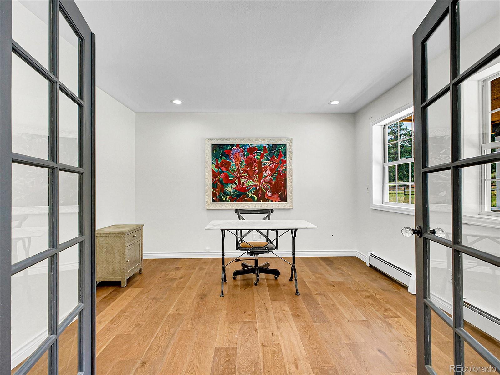 2635 Nova Road Pine, CO 80470 - Photo 6 of 45 a living room with furniture floor to ceiling window and a wooden floor