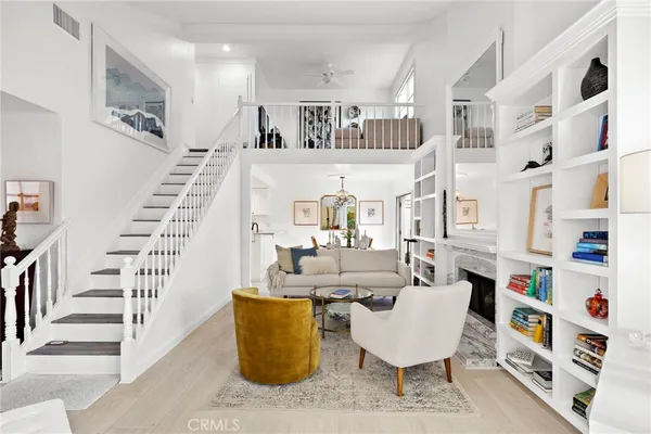 a living room with furniture and a book shelf