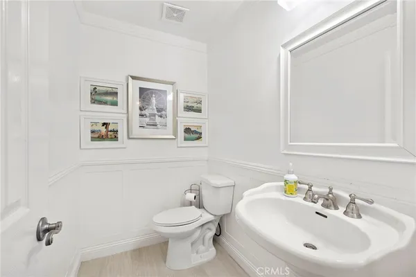 a bathroom with a sink mirror and toilet