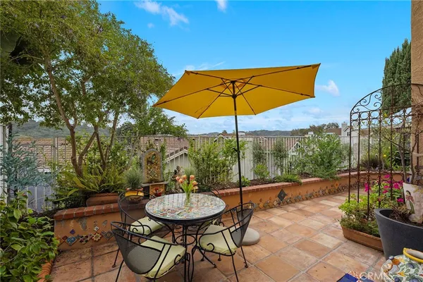 a view of a tables and chairs under an umbrella