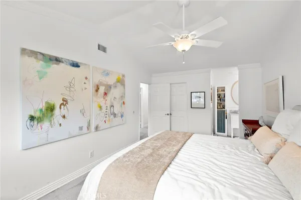 a bedroom with a large bed and a chandelier
