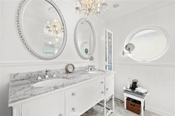 a bathroom with a double vanity sink and a mirror