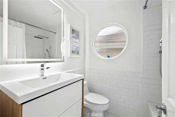 a bathroom with a sink a mirror and a toilet