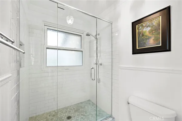 a bathroom with a shower and a toilet