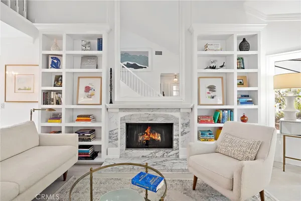 a living room with furniture cabinets and a fireplace