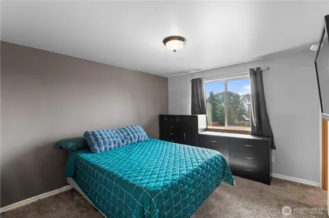 a bedroom with a bed and window