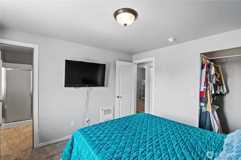 a bedroom with a bed and a flat screen tv