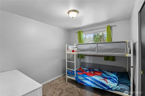 a bedroom with bed and window