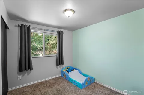 a view of room with window and air conditioner