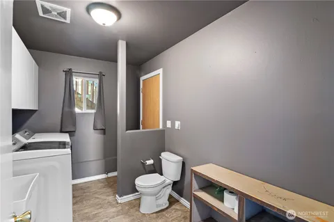 a bathroom with a toilet sink and mirror