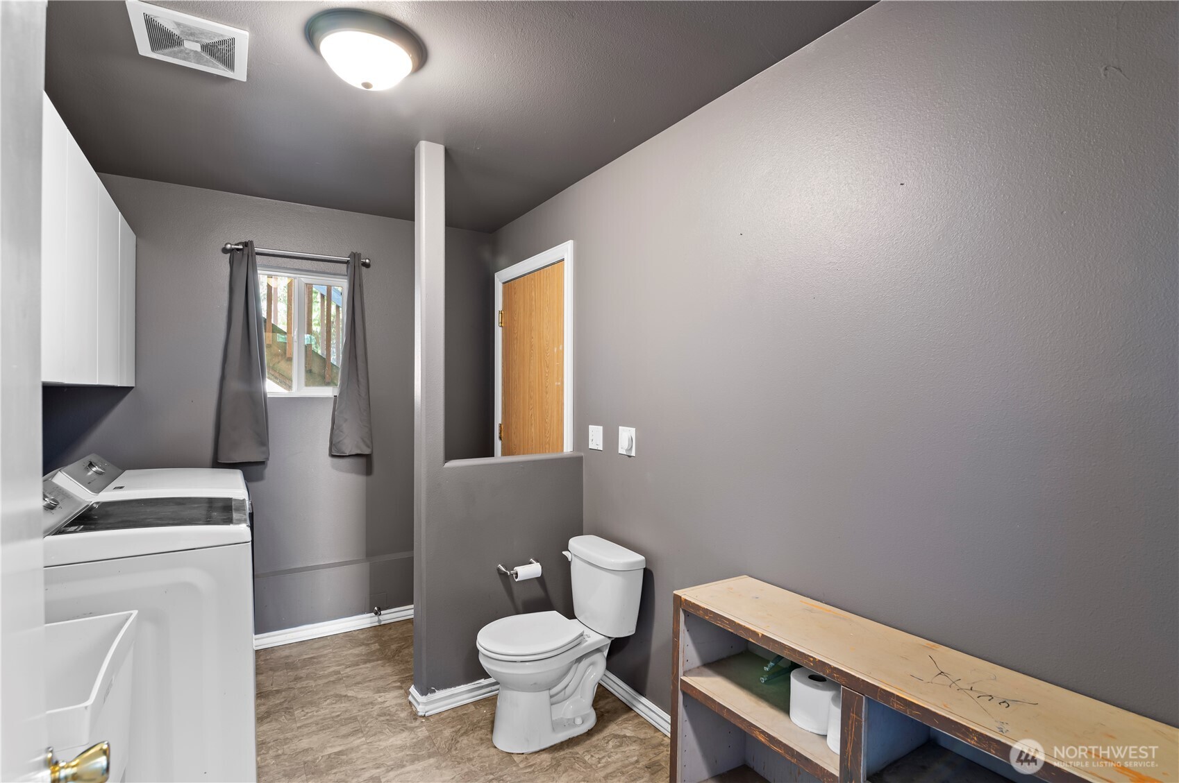 7805 260th Street Northwest Stanwood, WA 98292 - Photo 22 of 25 a bathroom with a toilet sink and mirror