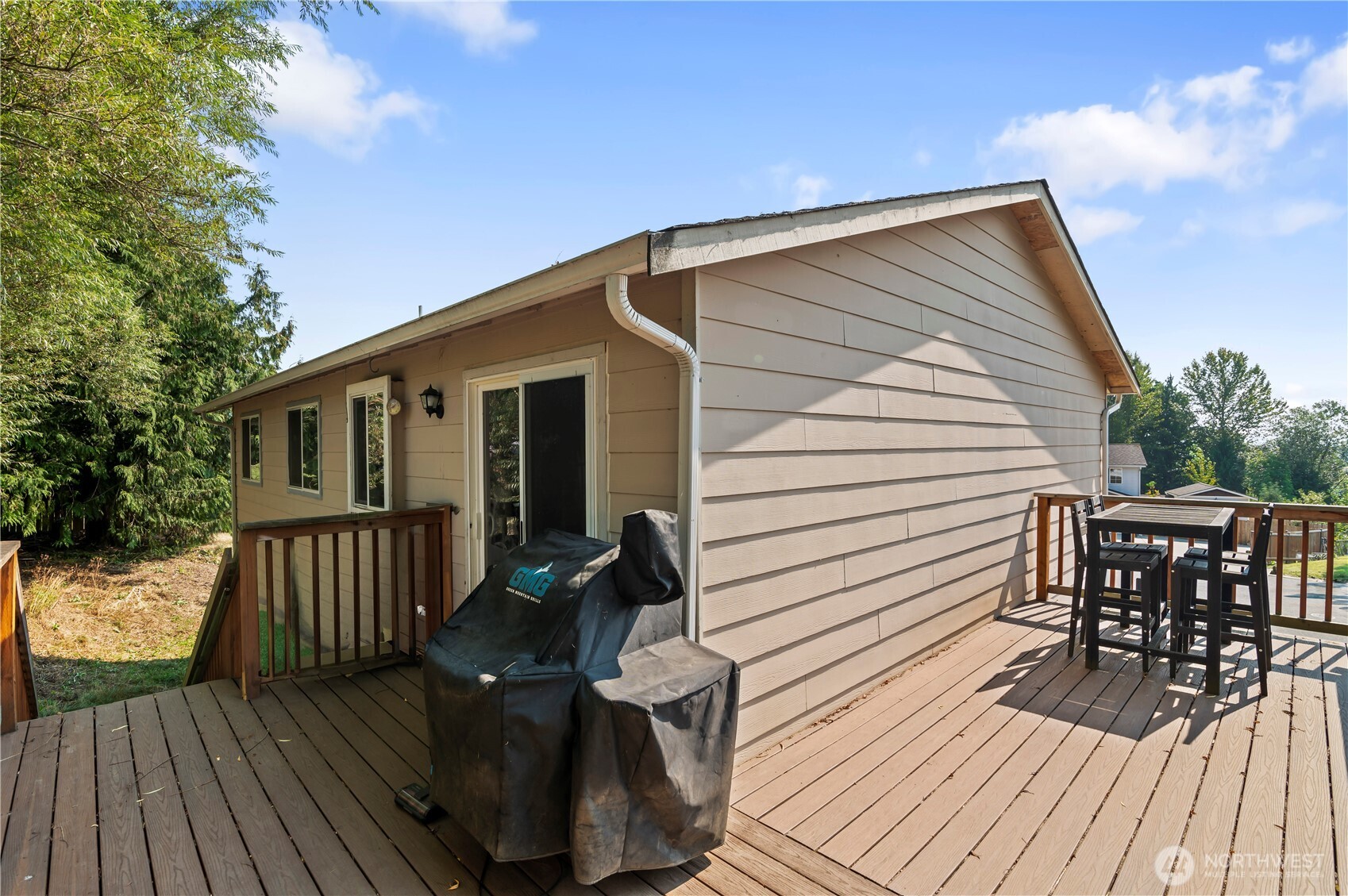 7805 260th Street Northwest Stanwood, WA 98292 - Photo 3 of 25 a view of deck with table and chairs and wooden floor