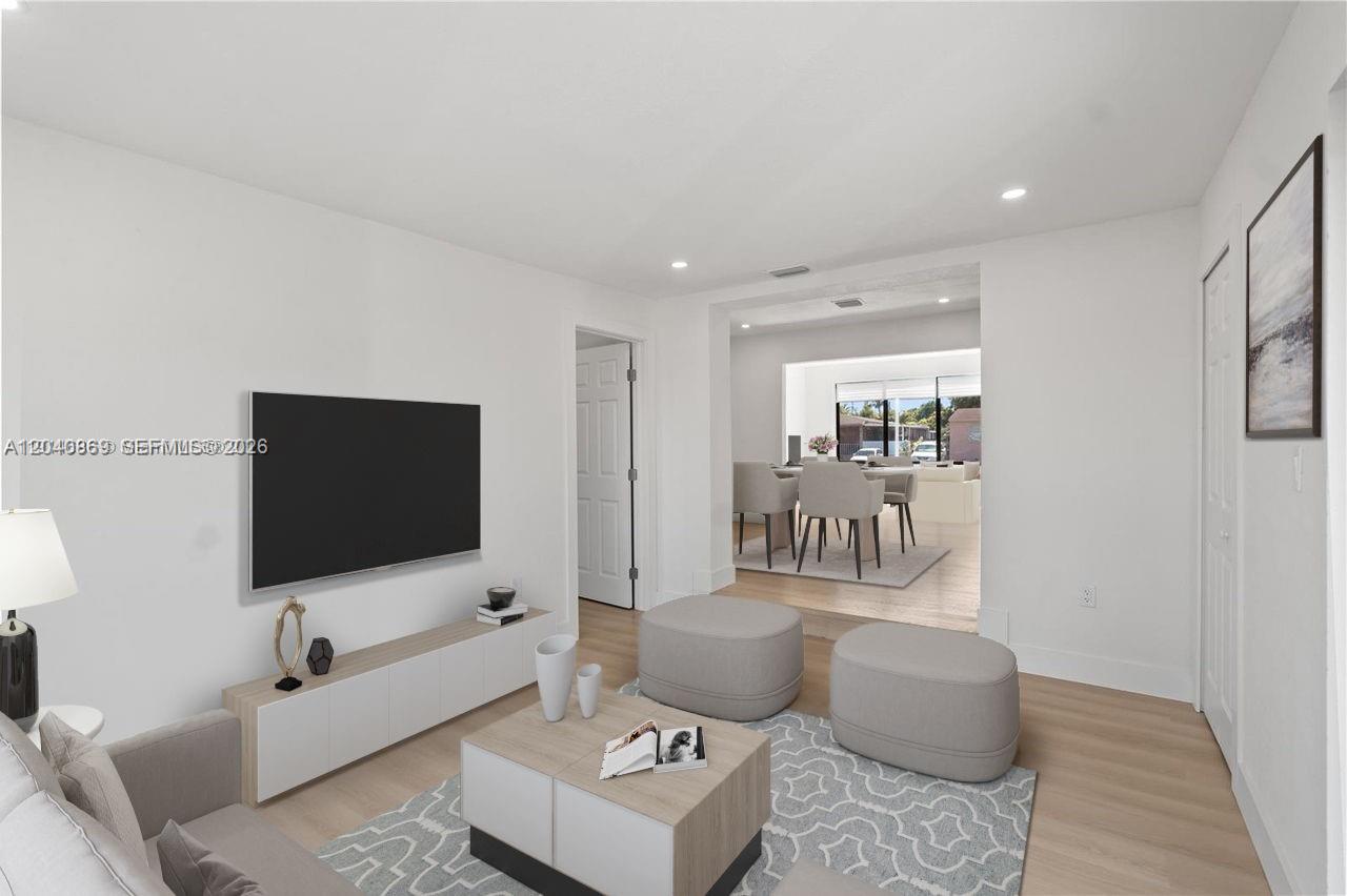31 West 64th Street Hialeah, FL 33012 - Photo 29 of 49 a living room with furniture and a flat screen tv