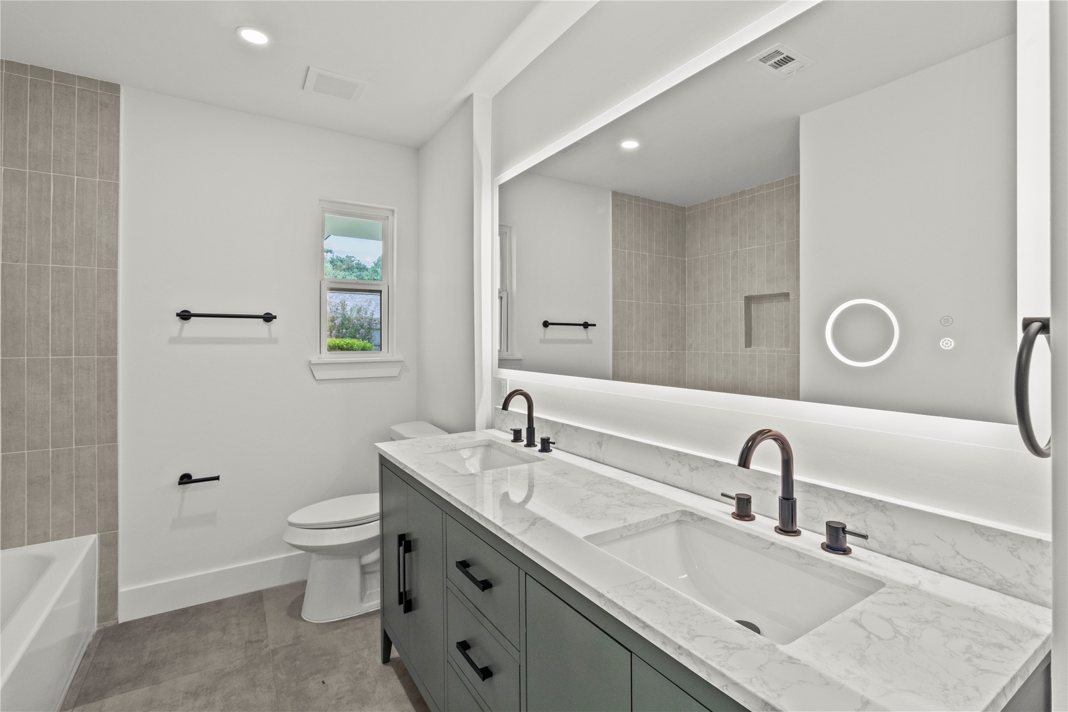 2823 Stetson Lane Houston, TX 77043 - Photo 10 of 19 a bathroom with a granite countertop sink a toilet and a mirror