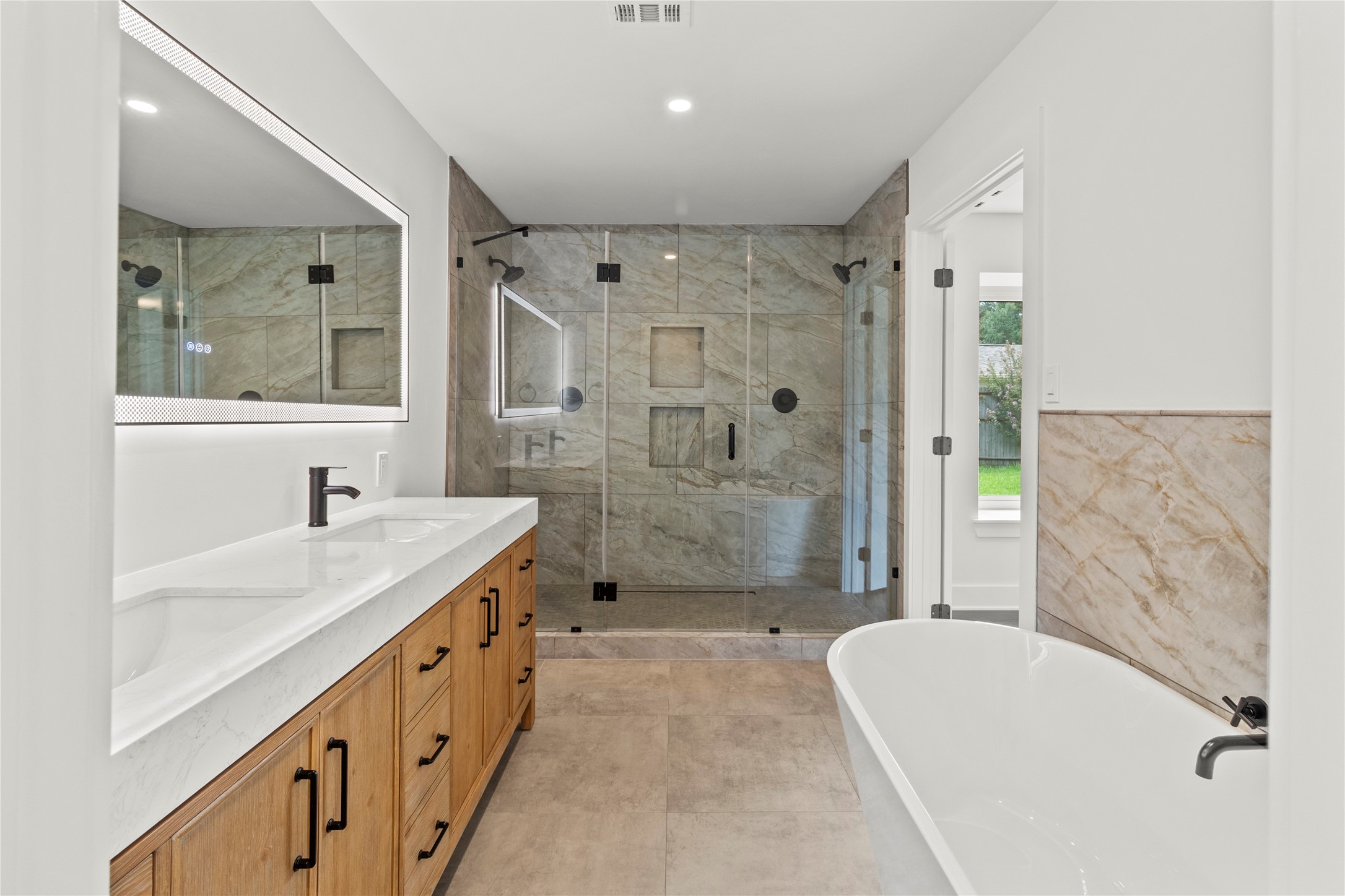 2823 Stetson Lane Houston, TX 77043 - Photo 11 of 19 a bathroom with a granite countertop sink a toilet a mirror and shower