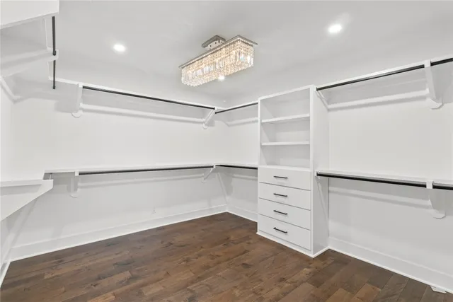 a bathroom with a granite countertop sink a mirror a vanity and a shower
