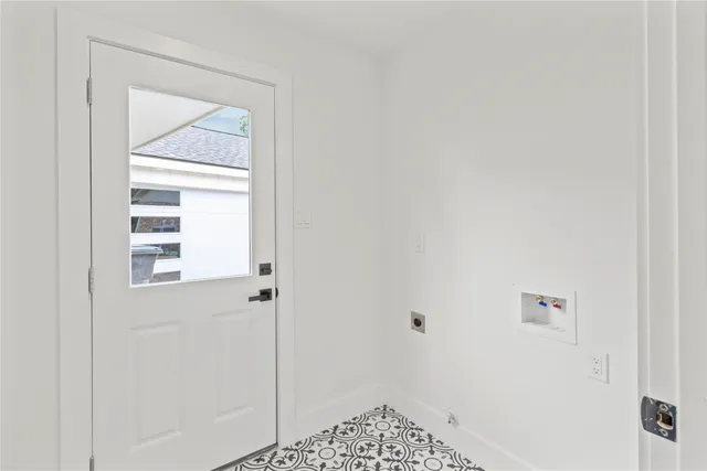 an empty room with a large window and wooden floor