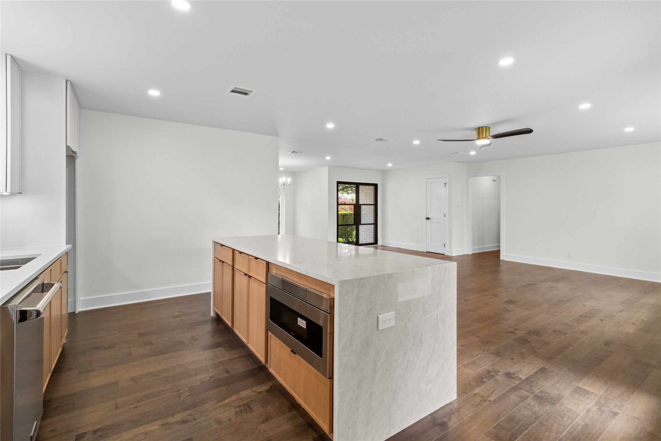 2823 Stetson Lane Houston, TX 77043 - Photo 4 of 19 a view of kitchen with stainless steel appliances granite countertop cabinets and wooden floor