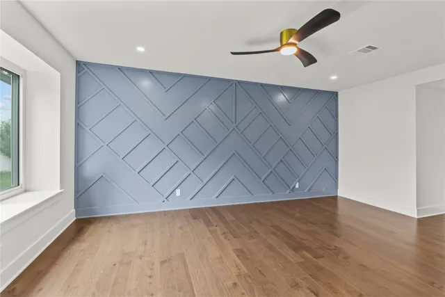 a bedroom with a large bed and a large window