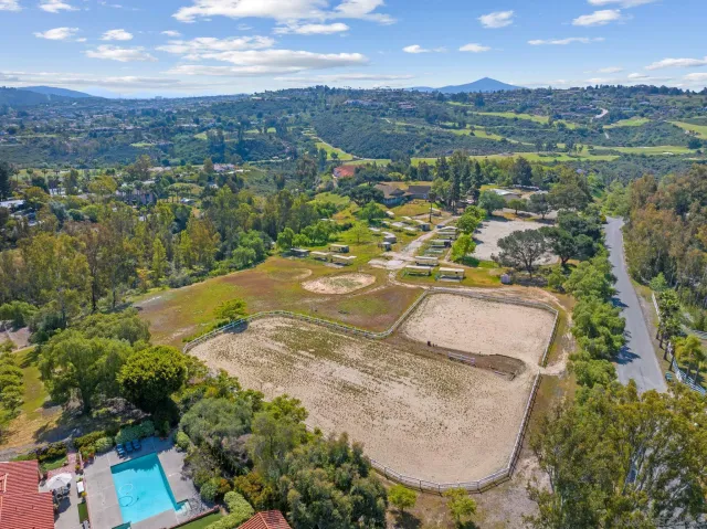 an aerial view of a house with a yard and lake view