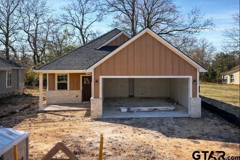 a view of a house with a yard covered in snow