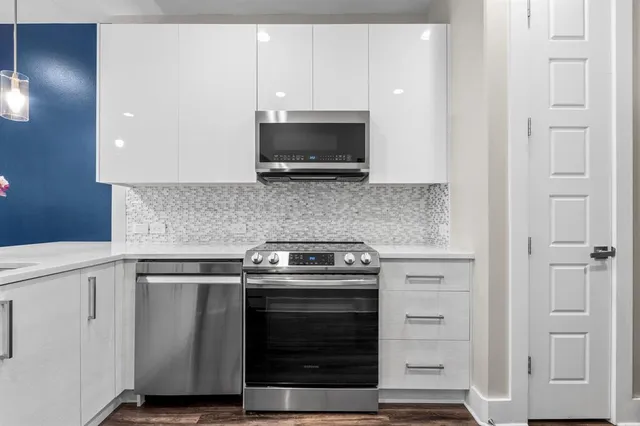 a bathroom with a sink vanity mirror and toilet
