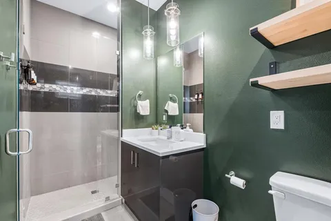 a bathroom with a toilet a sink and mirror