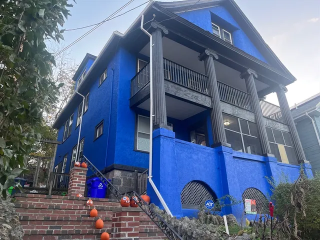 a view of a wooden house with large windows