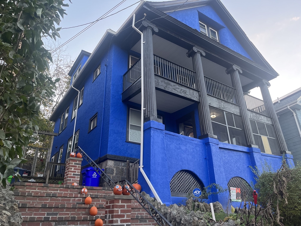 a view of a wooden house with large windows