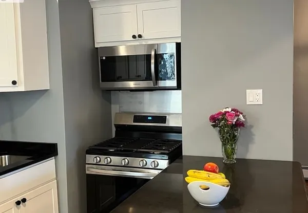 a kitchen with a stove and a microwave