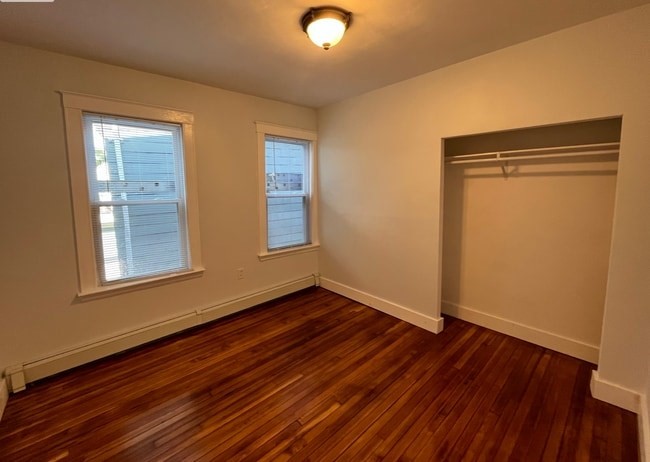 17 Townsend Street, Unit 1 Boston, MA 02119 - Photo 5 of 9 a view of an empty room with wooden floor and a window