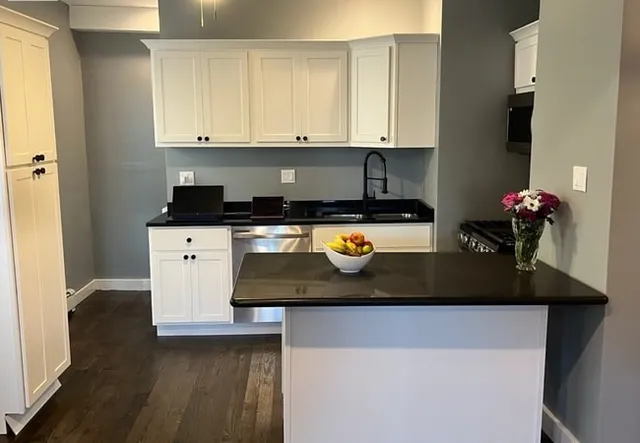 a kitchen with a sink a stove and cabinets
