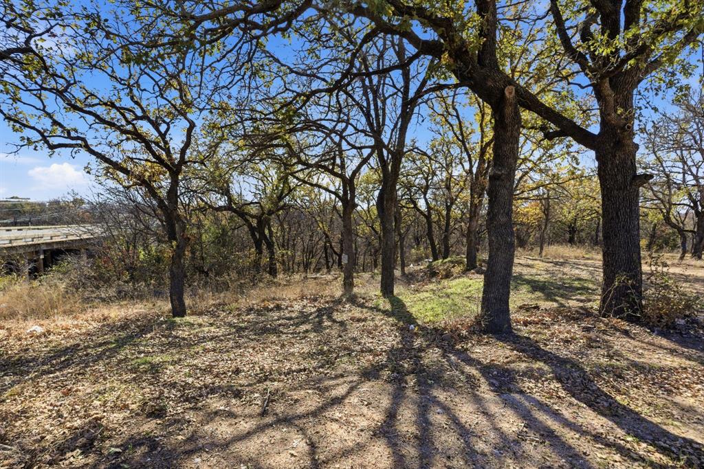 2410 State Highway South Graham, TX 76450 - Photo 18 of 19 a backyard of a house with lots of trees