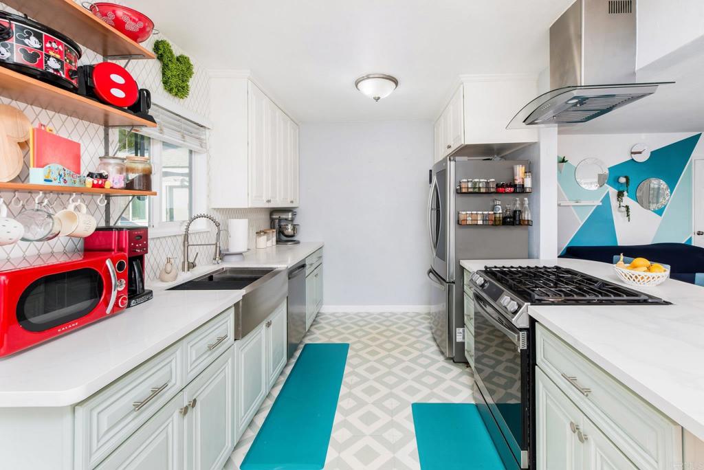 2914 Rosedale Court Spring Valley, CA 91977 - Photo 7 of 30 a kitchen with kitchen island a stove and a sink