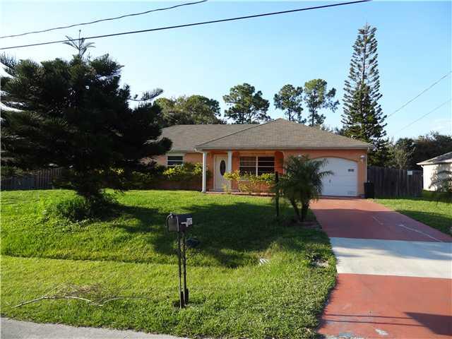 1601 Southwest Fortune Road Port St. Lucie, FL 34953 - Photo 1 of 23 a front view of house with yard and green space