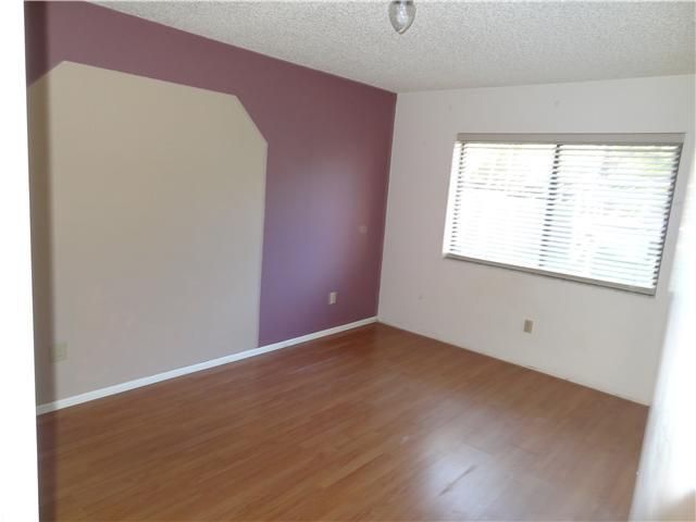1601 Southwest Fortune Road Port St. Lucie, FL 34953 - Photo 17 of 23 an empty room with wooden floor and windows