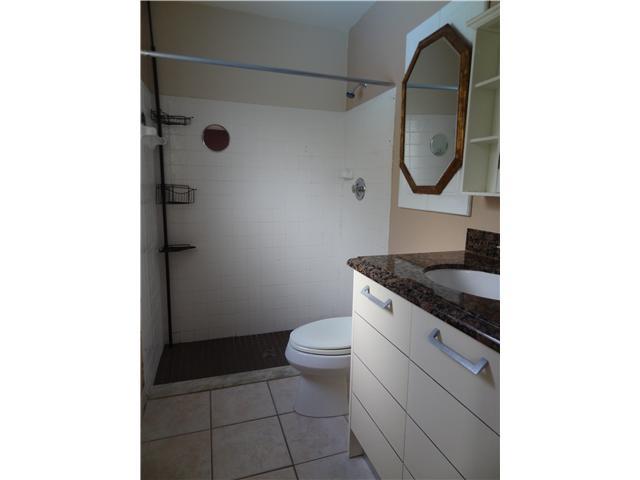 1601 Southwest Fortune Road Port St. Lucie, FL 34953 - Photo 18 of 23 a bathroom with a granite countertop toilet and a mirror