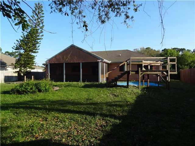 1601 Southwest Fortune Road Port St. Lucie, FL 34953 - Photo 22 of 23 a front view of a house with a yard