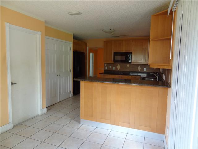 1601 Southwest Fortune Road Port St. Lucie, FL 34953 - Photo 9 of 23 a view of a kitchen with microwave and cabinets