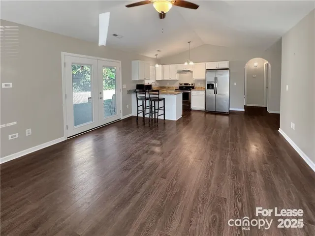 a view of a kitchen with furniture and wooden floor