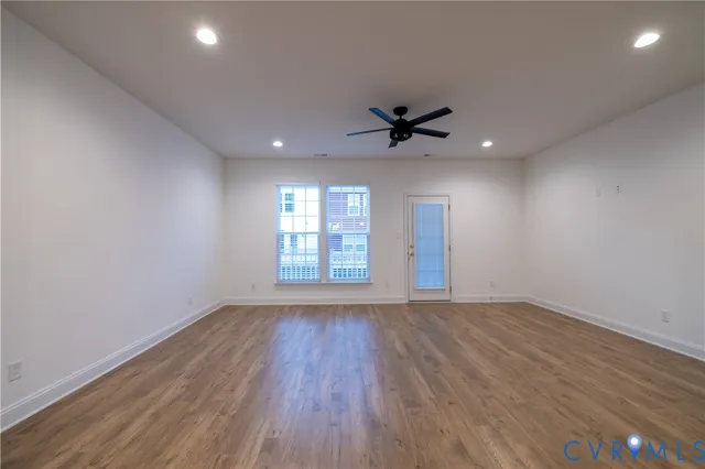 wooden floor in an empty room with a window