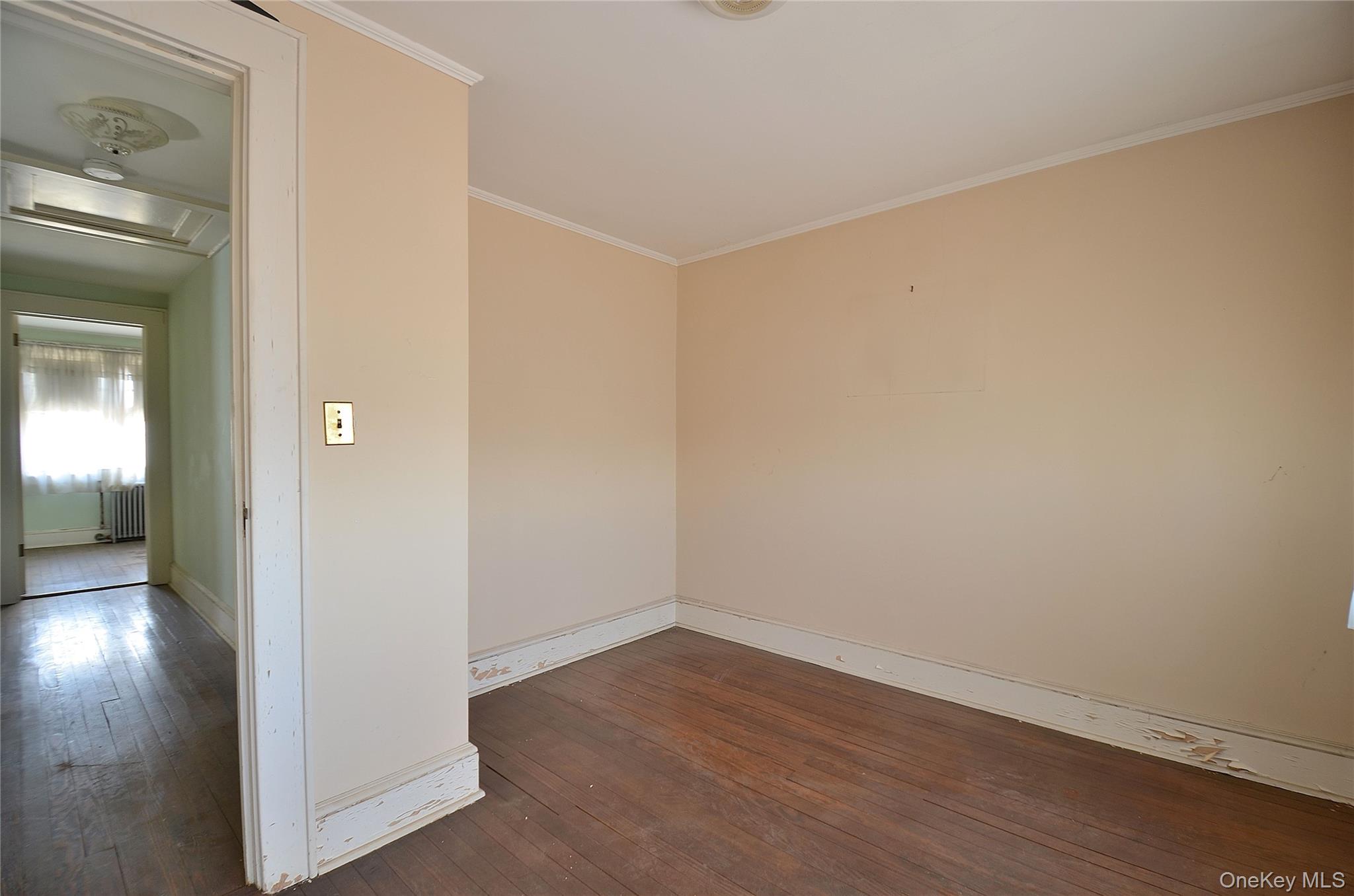 2586 Riverside Drive Wantagh, NY 11793 - Photo 16 of 28 Bedroom featuring hardwood flooring, light-toned walls, white trim, and a ceiling light fixture