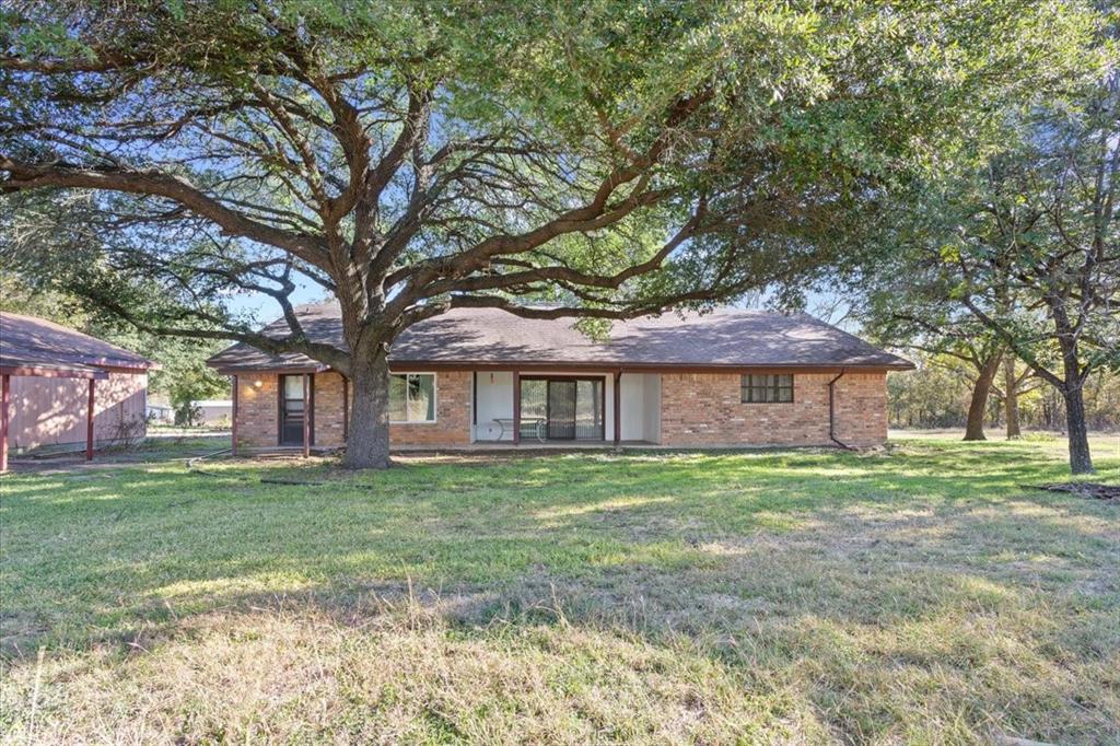 208 South Hedwig Street Riesel, TX 76682 - Photo 29 of 31 View of front facade featuring a front yard and brick siding