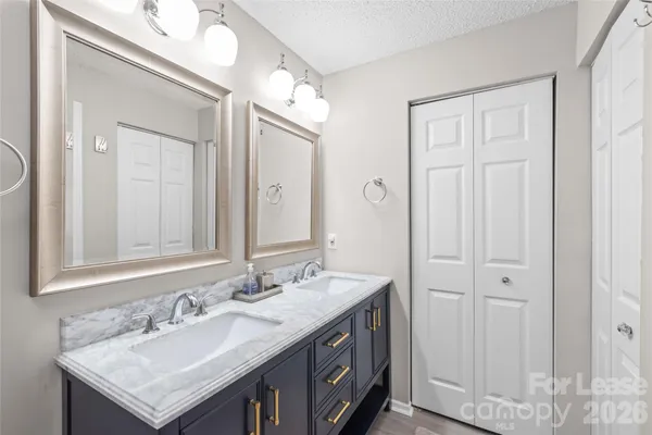 a bathroom with 2 sink and a mirror