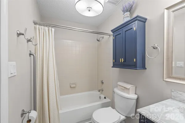 a bathroom with a toilet sink and shower