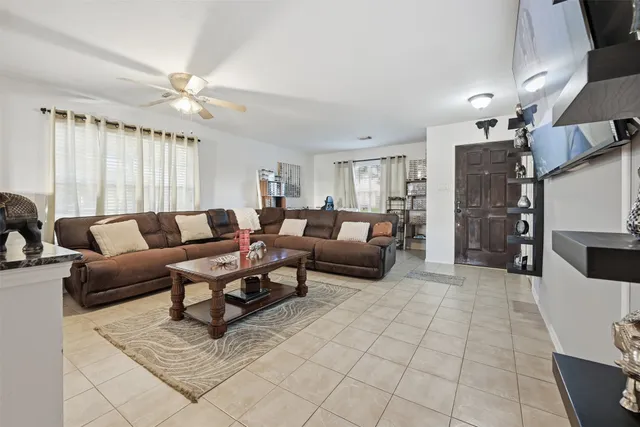 a living room with furniture and a chandelier