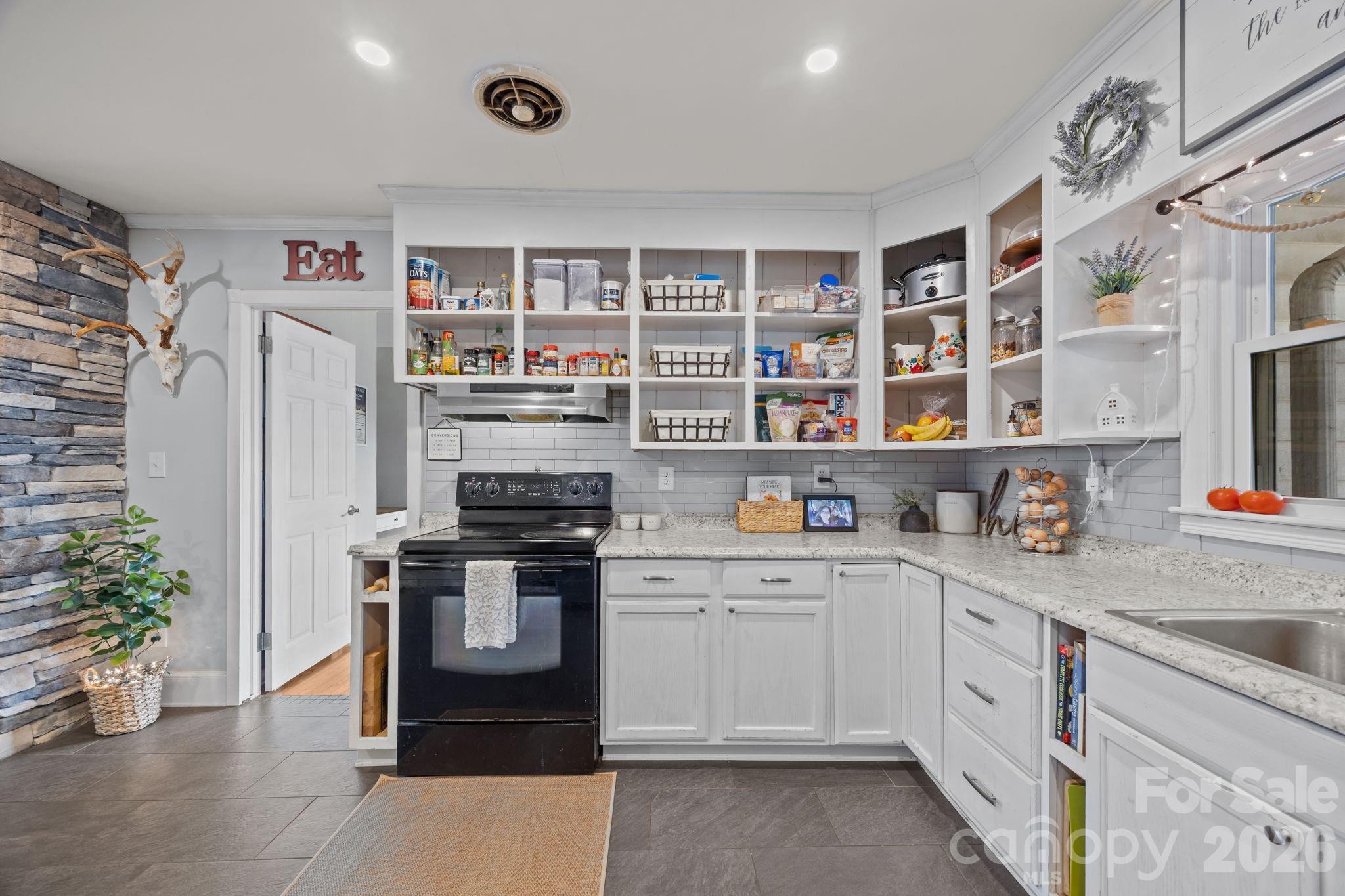 275 Tanner Street Rutherfordton, NC 28139 - Photo 26 of 44 a kitchen with stainless steel appliances granite countertop a stove and a refrigerator