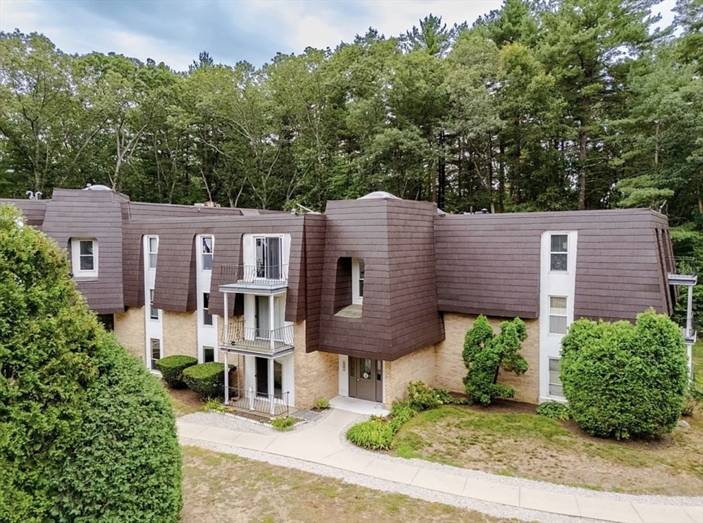 8 Shadowbrook Lane, Unit 38 Milford, MA 01757 - Photo 1 of 16 a front view of a house with garden