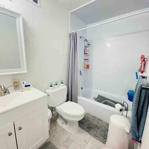a bathroom with a sink toilet vanity and shower