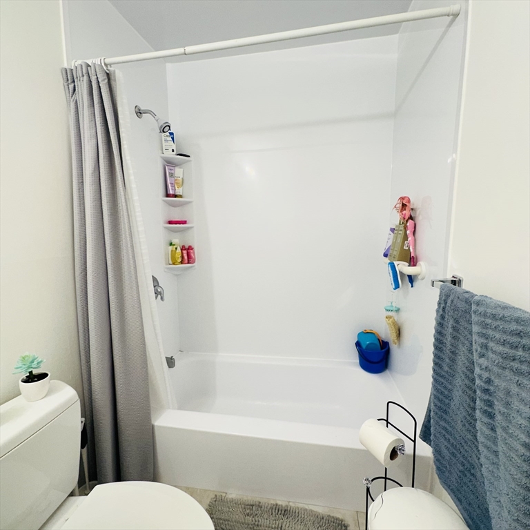 8 Shadowbrook Lane, Unit 38 Milford, MA 01757 - Photo 14 of 16 a bathroom with a sink a toilet and a shower curtain
